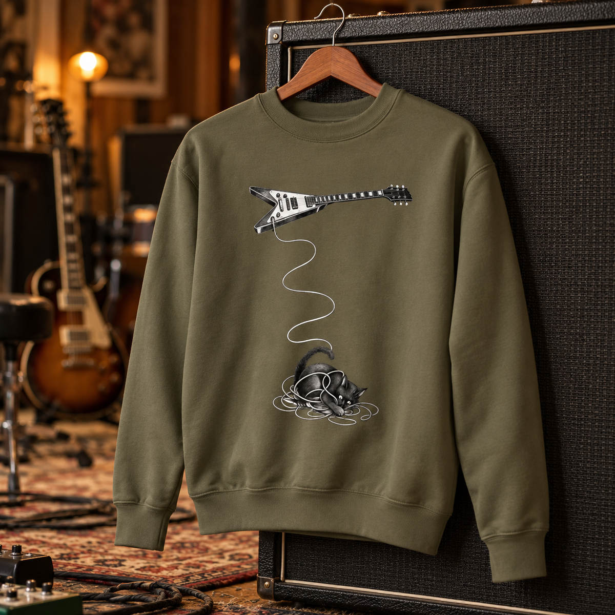Wired crewneck styled on a studio set – cat tangled in a guitar cable